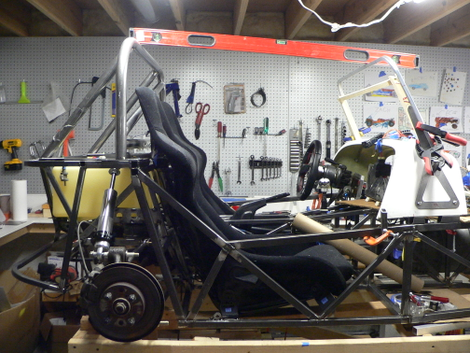 Installing the roll bar and windshield, still in the basement.